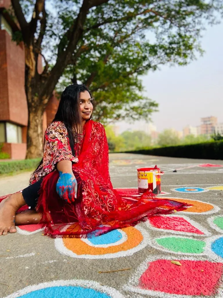 Shafrin Akter Chowdhury painting alpona on a campus road during Rong Chong 2.0.